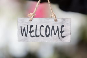 Cute welcome sign against blurred background